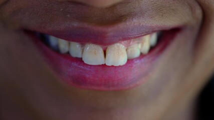Extreme macro close up of African American woman’s smile, natural expression revealing authenticity, warmth, and emotional depth through fine detail