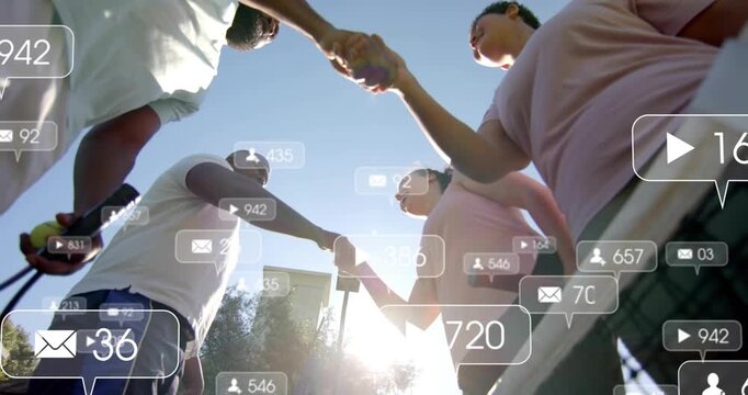 Four tennis players greeting at net shaking while racket player tapping phone floating social icons