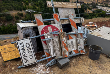 A Pile of used construction and street signs in a service yard.