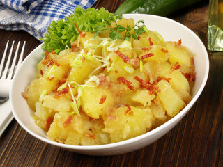 Food - Potato Salad with Bacon and Onions in a Bowl on wooden Background