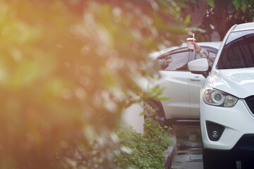 Customers receive coffee cups from drive-thru counter staff during rush hour.