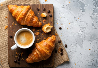 Croissants with coffee, wooden piece flat lay on plaster and piece of sack