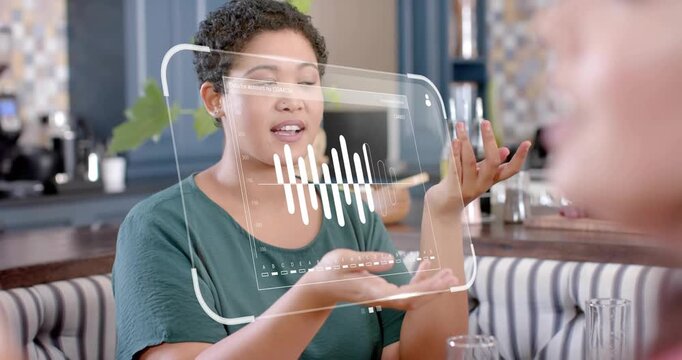 Woman gesturing, speaking at cafe booth, speech activating AR waveform over palms for voice demo