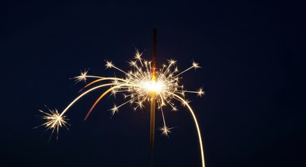 Fototapeta premium Golden glowing handheld sparkler emitting brilliant hot white light streaks against an isolated deep night sky backdrop, close up, cheer, backdrop