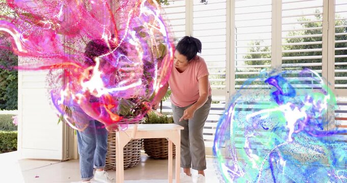 Mom and daughter pointing, rolling paint table for DIY as pink blue swirls partially obscuring them