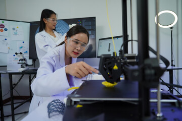 Engineers work with a 3D printer to print a clear white plastic model. State-of-the-art technology, selective focus, in a lab.