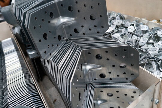 Stack of metal brackets and connectors in a hardware store showcasing various sizes and designs for construction projects and DIY tasks