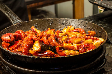 octopus menu being fried in a teflon pan