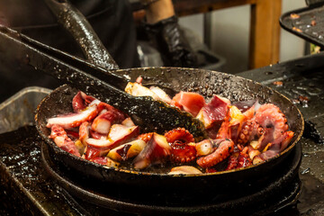 octopus menu being fried in a teflon pan