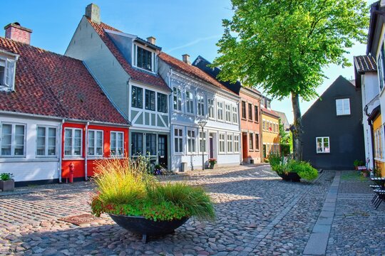 City street with traditional colorful houses, Odense, Denmark