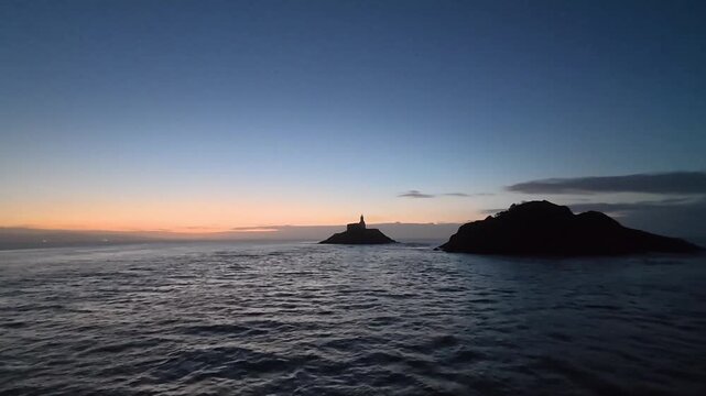 4K video of daybreak over the Mumbles Lighthouse in West Glamorgan, Wales