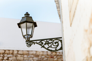 A close-up view of a decorative street lantern in Faro, Algarve, Portugal
