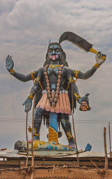 Rangiyam, Tamil Nadu, India - October 10, 2013: fierce form of the goddess Kali Amman, Bhadrakali, as victorious and protective, on top of Shi Dharshanakali Amman temple under cloudscape