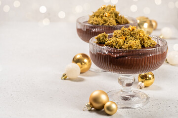 Festive dessert in glass bowl with decorative stars and Christmas ornaments in the background