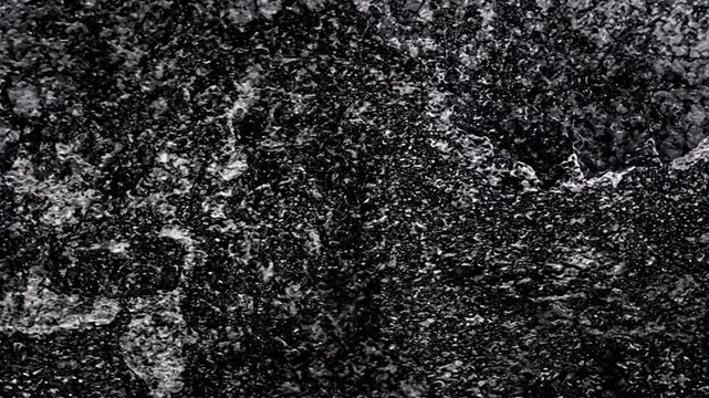 Wide shot video of a monochrome abstract sufrace texture with slow zoom efect motion seamless looped animated video