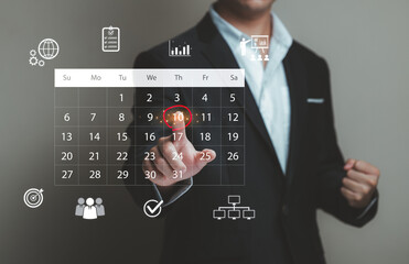 Businessperson Selecting Date on Interactive Calendar Interface with Graphs and Icons for Management and Productivity Planning