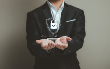 Businessman in Suit Holding Virtual Shield with Lock Icon Representing Cybersecurity and Data Protection Concept in Modern Digital Environment