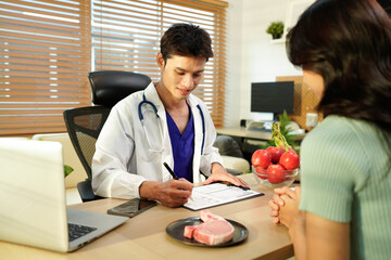 Dietician, male nutrition specialist consulting woman, developing healthy diet, dietary program. Dietary consultant asking, giving male patient advice, help, nutritional information, new meal plan