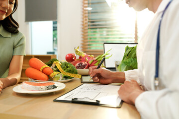 Dietician, male nutrition specialist consulting woman, developing healthy diet, dietary program. Dietary consultant asking, giving male patient advice, help, nutritional information, new meal plan