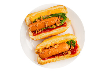 Hotdog fried onions, sausage, bun, sauce fast food tasty snack fresh delicious gourmet food background on the table rustic top view copy space