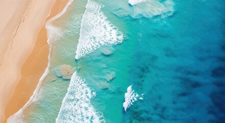 Aerial view of a sandy beach with turquoise water and gentle waves rolling onto the shore, showcasing the beautiful coastline from above