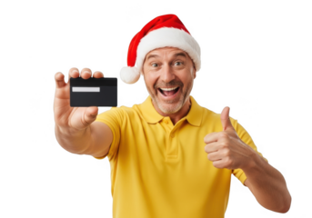 Excited man wearing a santa hat, holding a black credit card and giving a thumbs up, isolated on transparent background