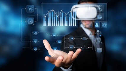 A business professional uses a virtual reality headset to interact with data visualizations and graphs, showcasing modern technology in a collaborative environment. Raster