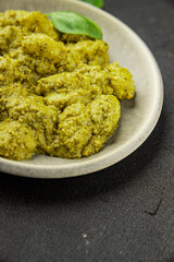 Gnocchi pesto sauce green tasty snack fresh gourmet food background on the table rustic top view copy space vegerian and vegan food