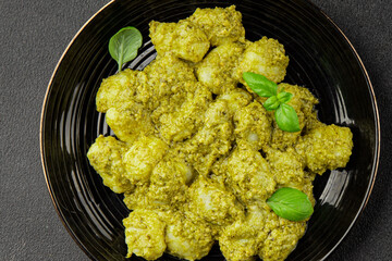 Gnocchi pesto sauce green tasty snack fresh gourmet food background on the table rustic top view copy space vegerian and vegan food