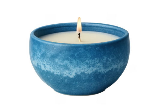 Scented candle burning in blue ceramic bowl