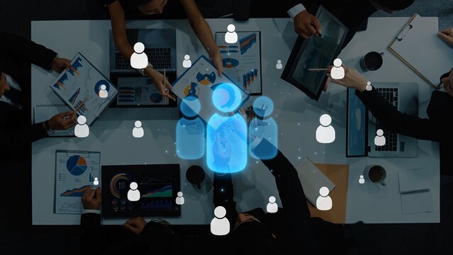 Aerial view of a diverse team engaged in collaboration with digital tools and data analytics, representing modern business dynamics and innovative strategies for success. Raster