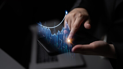 A close-up view of a person analyzing financial graph data on a smartphone, showcasing digital...