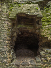A crumbling medieval stone oven built into a weathered wall (Conwy, Wales, United Kingdom)