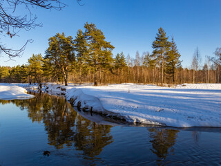 Snowy landscape with a river and trees
