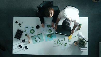 Top down view of business man presenting sustainable idea to manager by using tablet display ESG...