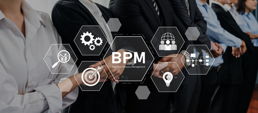 Professionals in business attire collaborate on innovative strategies for effective business process management, focusing on performance and organizational efficiency. Trope - Powered by Adobe