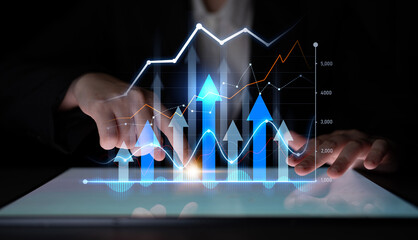 Close-up view of a professional analyzing growth trends using a digital tablet. The vibrant graph showcases analytics and data visualization in a modern office setting. Scalp