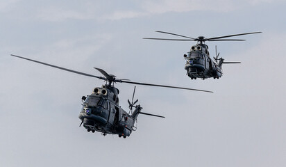 A pair of attack helicopters flying in formation