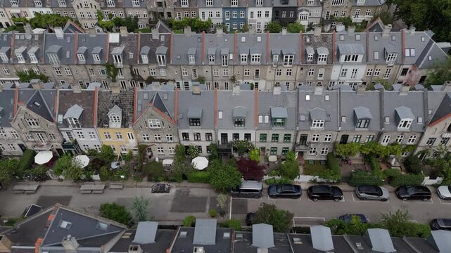 Aerial tilt up shot of the Potato Rows, a historic residential area in Copenhagen, Denmark, known for its distinctive rows of 19th-century terraced houses.