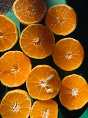 Sliced ripe Cypriot mandarins prepared for fresh juice, glowing in the warm morning sunlight