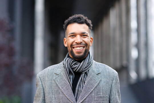 Portrait of smiling man in suit on city street