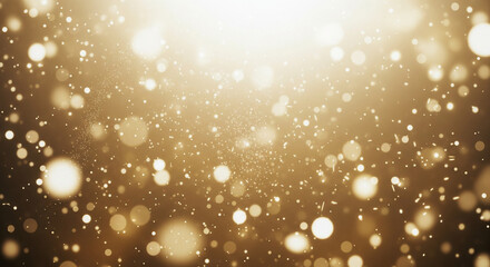 Golden glittering particles and bokeh on dark background.