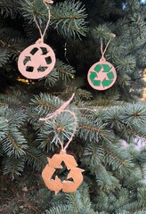 Christmas tree decoration in the form of a recycling symbol. A recycling symbol made of cardboard...
