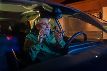 Businessman ignoring safety and sending voice message on mobile while driving