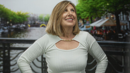 Woman shows upper chest skin and stands with hands on hips on street; confidence empowerment...