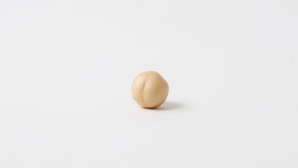 A small round dough ball on a plain white background.