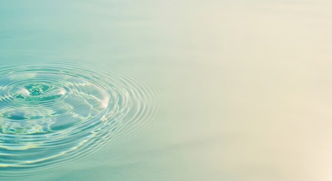 Closeup of ripples on the surface of clear, tranquil turquoise water, with soft light creating a serene and calming atmosphere, perfect for relaxation and wellness themes