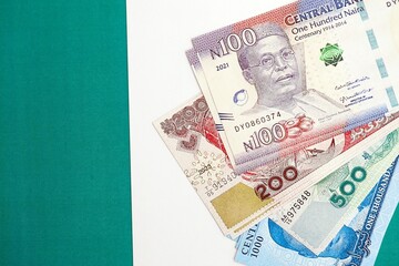 Nigerian naira currency money bills lies on flag close up. The concept of business and investment