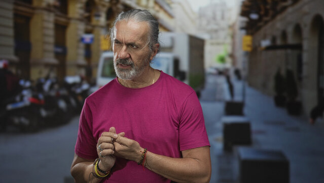 Man presses his fingers together on a busy city street beside a taxi and delivery van; concern reflection.