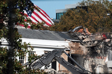 Fototapeta premium Demolition Crew Removing Facade of Constructed Building